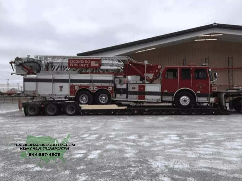 MOVING FIRE TRUCKS ON A FLATBED TRAILER